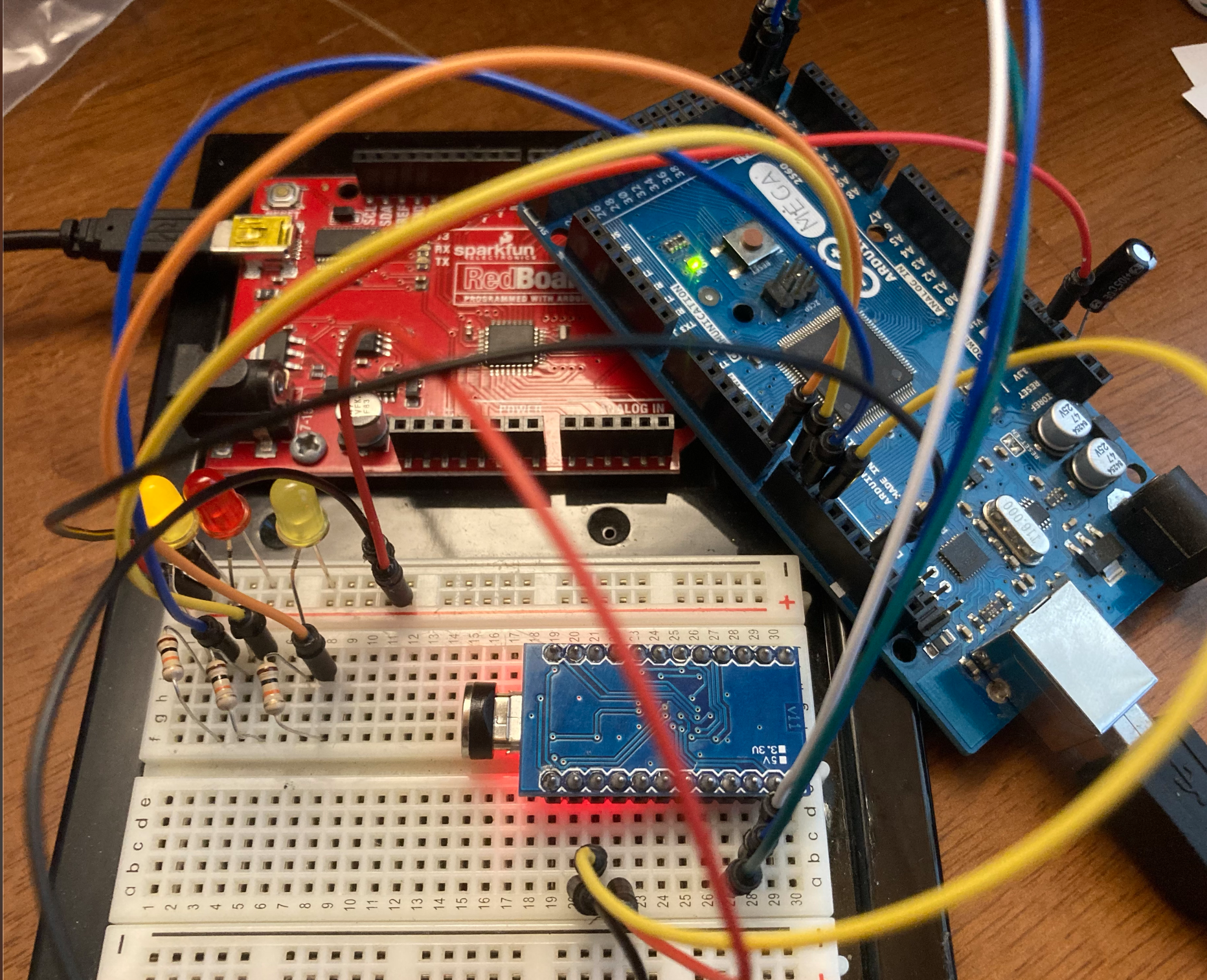 My workbench of shame. An arduino being used as an ISP programmer for a promicro plugged into a breadboard attached to a completely unrelated board.